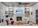 Cozy living room with built-in shelves, fireplace, and a ceiling fan at 1081 Groves Manor Ct, Mount Pleasant, SC 29464