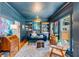 Cozy living room featuring custom built-in shelves, rich blue walls, stylish furnishings, and abundant natural light at 1081 Groves Manor Ct, Mount Pleasant, SC 29464