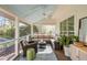 Inviting screened porch with cozy seating, ceiling fan, and view of the backyard at 1081 Groves Manor Ct, Mount Pleasant, SC 29464