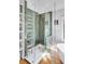 Elegant bathroom with a glass-enclosed shower featuring stylish green tiling and modern fixtures at 1081 Groves Manor Ct, Mount Pleasant, SC 29464