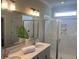 Bright bathroom with double sinks, a glass-enclosed shower, and neutral-toned walls at 109 Crosscut Ln, Summerville, SC 29486