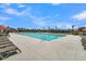 Luxurious community pool with lounge seating, umbrellas, and surrounding palm trees on a sunny day at 109 Crosscut Ln, Summerville, SC 29486