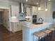 Modern kitchen featuring a kitchen island with seating, stainless appliances, and white cabinets at 109 Crosscut Ln, Summerville, SC 29486