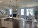 Open kitchen flowing into the dining and living areas, stainless appliances, and an island sink at 109 Crosscut Ln, Summerville, SC 29486