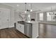 Open-concept kitchen with stainless steel appliances, a kitchen island, and hardwood floors at 109 Crosscut Ln, Summerville, SC 29486