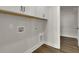 Functional laundry room with upper cabinets and hardwood floors at 109 Crosscut Ln, Summerville, SC 29486