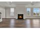 Spacious living room with a fireplace, hardwood floors, and large windows at 109 Crosscut Ln, Summerville, SC 29486