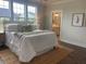 Serene bedroom featuring hardwood floors, a neutral palette, and en-suite bathroom access at 109 Crosscut Ln, Summerville, SC 29486