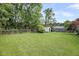 A spacious backyard with mature trees providing shade and privacy at 1135 Shoreham Rd, Charleston, SC 29412