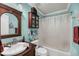 Cozy bathroom featuring a wood-framed mirror, blue walls, and a shower-tub combo at 1135 Shoreham Rd, Charleston, SC 29412