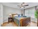 Bedroom features a dark wood bed frame, ceiling fan, and large window at 1135 Shoreham Rd, Charleston, SC 29412
