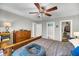 Comfortable bedroom features a ceiling fan, wood furniture, and lots of natural light at 1135 Shoreham Rd, Charleston, SC 29412