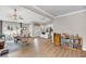 Bright open-plan living room with hardwood floors, vaulted ceiling and a modern kitchen in the background at 1135 Shoreham Rd, Charleston, SC 29412