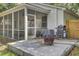Backyard with a grill, fire pit, concrete patio, and screened porch; fully fenced at 115 Ridge Rd, Summerville, SC 29485