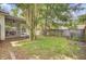 The backyard features a screened-in porch, fenced yard, and mature trees at 115 Ridge Rd, Summerville, SC 29485