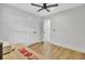 Neutral bedroom with light wood floors, ceiling fan, and doorway leading to another room at 115 Ridge Rd, Summerville, SC 29485