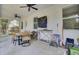 Spacious covered patio with a grill and multiple ceiling fans, ready for relaxing or entertaining at 115 Ridge Rd, Summerville, SC 29485
