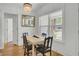 Cozy dining room area, view of table and chairs, lit by a chandelier and window at 115 Ridge Rd, Summerville, SC 29485