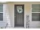 Close up of front door and wreath next to 'welcome' sign and big windows at 115 Ridge Rd, Summerville, SC 29485