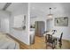 Open concept kitchen with stainless steel appliances, granite counters and dining area with modern chandelier at 115 Ridge Rd, Summerville, SC 29485