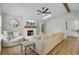 Cozy living room with fireplace, skylight, ceiling fan, and sliding glass doors to patio at 115 Ridge Rd, Summerville, SC 29485