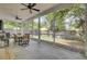 Inviting screened porch with ceiling fans, dining table and view of backyard at 115 Ridge Rd, Summerville, SC 29485