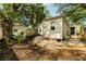 Spacious backyard with deck, mature trees, and a charming cottage-style home at 116 Magnolia Ave, Charleston, SC 29403