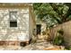 Inviting backyard with wooden deck, mature trees, and charming outdoor seating area at 116 Magnolia Ave, Charleston, SC 29403