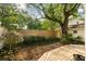 Lush backyard with wooden deck, privacy fence, and mature trees at 116 Magnolia Ave, Charleston, SC 29403