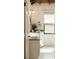 Bathroom vanity with open door revealing modern design, white paint, wood ceiling at 116 Magnolia Ave, Charleston, SC 29403