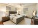 Well-lit bedroom featuring a plush bed, a ceiling fan, and three windows at 116 Magnolia Ave, Charleston, SC 29403