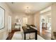 Dining room with a modern chandelier, hardwood floors, a large table, and stylish decor, perfect for gatherings at 116 Magnolia Ave, Charleston, SC 29403