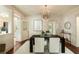 Bright dining room featuring hardwood floors, stylish decor, and access to a kitchen area at 116 Magnolia Ave, Charleston, SC 29403