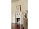 Close-up of a classic white brick fireplace with decorative accents and birch logs, adding warmth and character to the room at 116 Magnolia Ave, Charleston, SC 29403