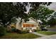 Cozy single-story home with well-lit windows, a golf cart, an awning and a lush green lawn at 116 Magnolia Ave, Charleston, SC 29403