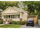 Charming single-story home with manicured lawn and quaint awning and adjacent parking with golf cart at 116 Magnolia Ave, Charleston, SC 29403