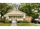 Charming single-story home with manicured lawn, quaint awning, and adjacent parking with golf cart at 116 Magnolia Ave, Charleston, SC 29403