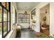 Inviting front porch with bench, a small table, and views to a sunny interior at 116 Magnolia Ave, Charleston, SC 29403
