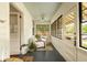 Relaxing front porch space featuring comfortable seating and windows that provide lots of natural light at 116 Magnolia Ave, Charleston, SC 29403