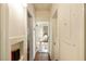 Bright hallway with hardwood floors, views of different rooms, and white wainscoting at 116 Magnolia Ave, Charleston, SC 29403