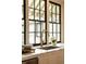 A stunning Kitchen sink with Marble countertops and dark framed windows at 116 Magnolia Ave, Charleston, SC 29403
