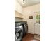 Modern laundry room with gray washer and dryer, and exterior door at 116 Magnolia Ave, Charleston, SC 29403