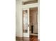 Elegant view of a living room with hardwood floors, showcasing the architectural details and a glimpse into another room at 116 Magnolia Ave, Charleston, SC 29403
