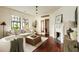 Bright living room with hardwood floors, fireplace, and a doorway leading to a hall at 116 Magnolia Ave, Charleston, SC 29403