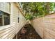 Narrow side yard with wooden fence and access to backyard at 116 Magnolia Ave, Charleston, SC 29403