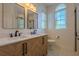 Bathroom featuring a double vanity, natural wood cabinet, and shiplap walls at 117 Lucia St, Charleston, SC 29492