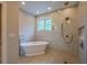 Bright bathroom featuring a soaking tub and walk-in shower with intricate tile at 117 Lucia St, Charleston, SC 29492