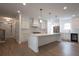 New kitchen features stainless steel appliances, white cabinetry and a large center island at 117 Lucia St, Charleston, SC 29492