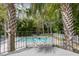 Backyard pool view from elevated deck with iron railing and lush landscaping at 117 Lucia St, Charleston, SC 29492
