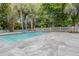 Backyard swimming pool with cool blue tiles and stone tile patio at 117 Lucia St, Charleston, SC 29492